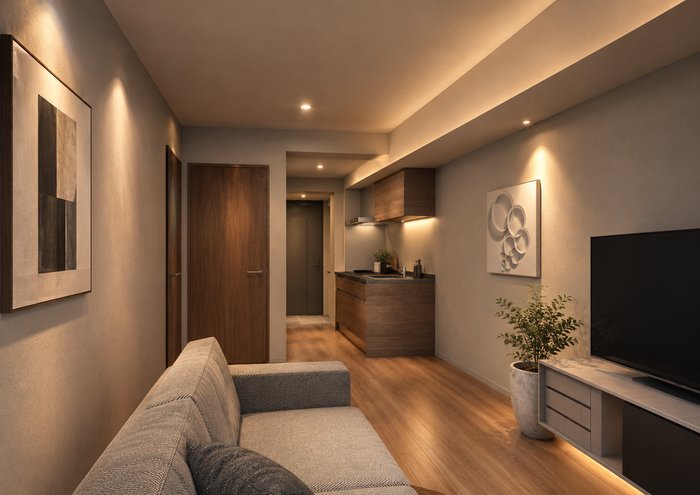 Le Cadeauの住戸内観イメージ。ソファとテレビを置いた間接照明の居室と奥の壁付けキッチン